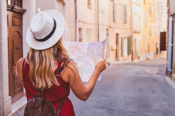istockphoto-1020217050-612x612 A woman in a white hat is holding a map