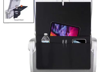 A black chair with a phone and water bottle in it.