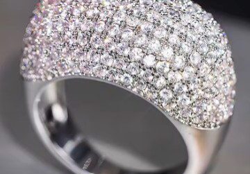 A close up of a ring with many diamonds