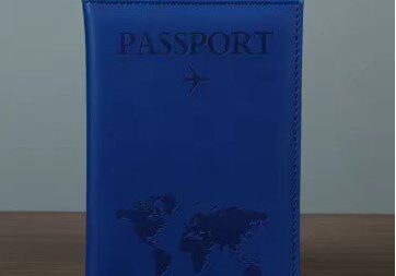 A blue passport cover sitting on top of a table.