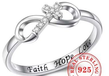 A silver ring with an infinity symbol and cross.