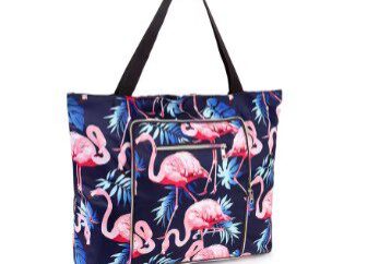 A flamingo print tote bag with black handles.