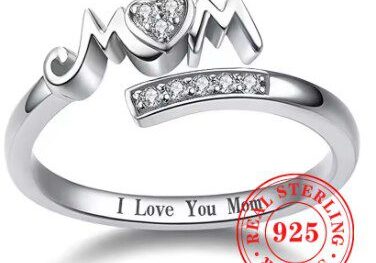A silver ring with the word mom and a heart.