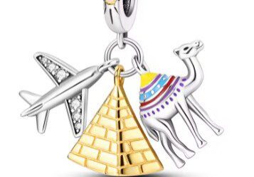A gold and silver charm with an airplane, camel, pyramid and camel.