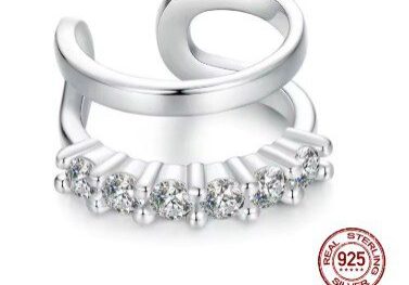 A silver ring with a row of diamonds on it.