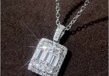A diamond necklace with a square shaped pendant.