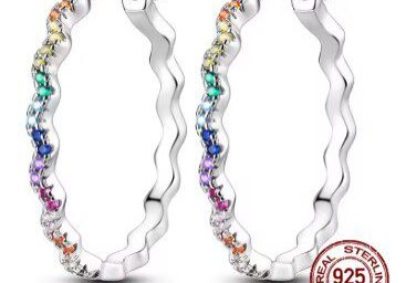 A pair of rainbow colored hoop earrings.