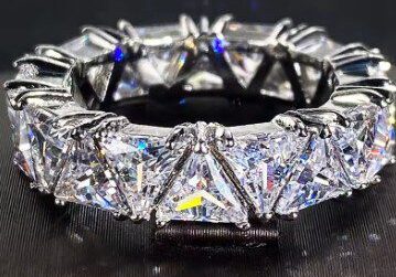 A close up of a diamond ring on top of a table.