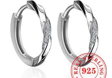 A pair of silver earrings with a number on it.