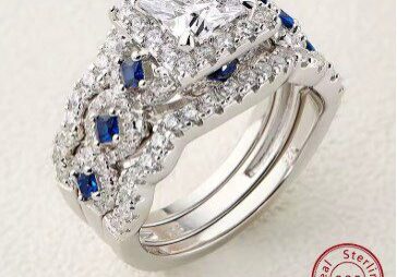 A diamond and sapphire ring set on top of each other.