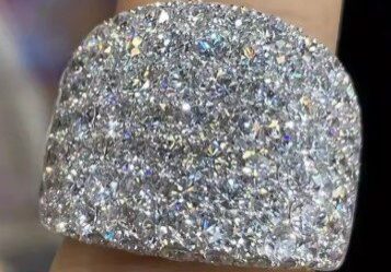 A person is holding onto the ring of silver