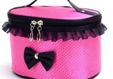 A pink and black bag with a bow on it