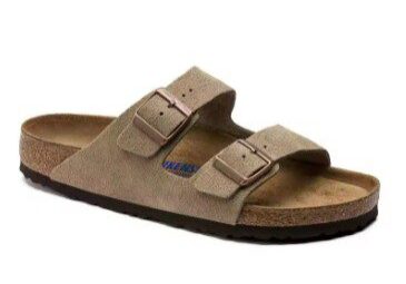 A pair of sandals that are tan and brown.