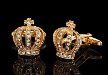 A pair of gold plated cufflinks with a crown design.
