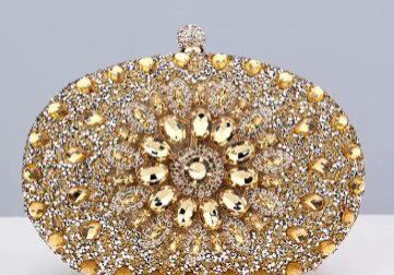 A gold and silver purse with many stones on it