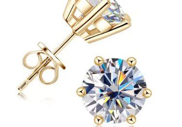 A pair of gold earrings with a diamond on top