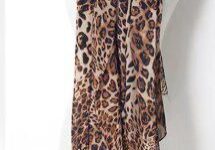 A leopard print scarf is hanging on the wall.