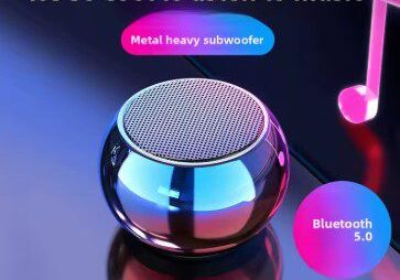 A blue and pink bluetooth speaker sitting on top of a table.