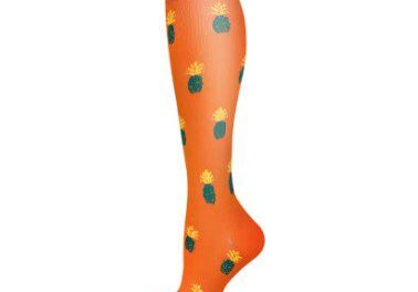 A pair of orange socks with green and yellow designs.