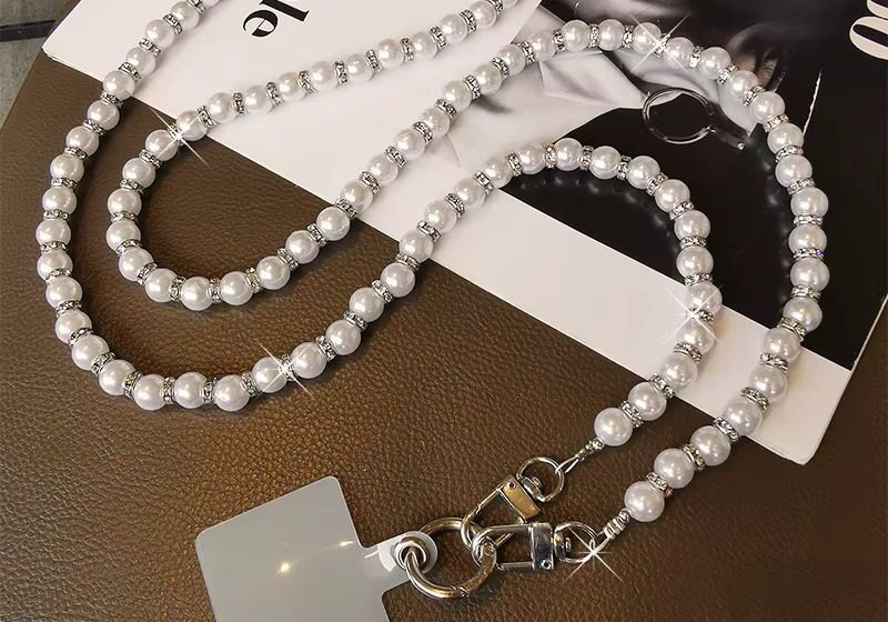 A necklace with pearls and a card holder.