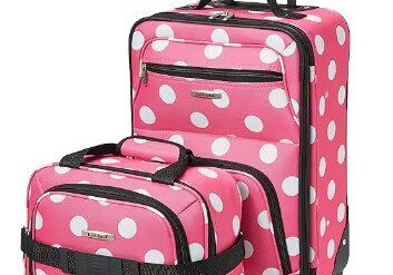 A pink polka dot suitcase and bag on wheels.