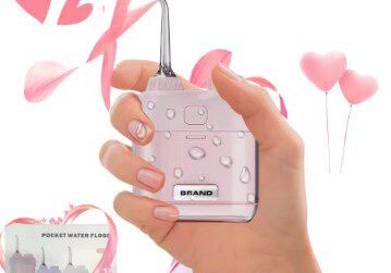 A hand holding a pink cell phone with hearts on it.