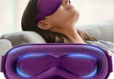 A woman laying on the couch with her eyes closed.