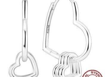 A pair of silver earrings with hearts on them.