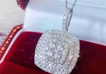 A diamond necklace sitting in a red box.