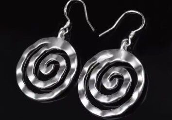 A pair of silver earrings with spirals on them.