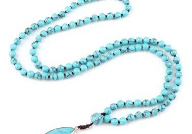 A long necklace with turquoise beads and a blue pendant.