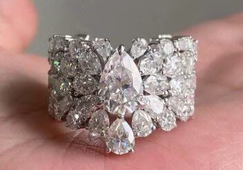 A person holding onto a diamond ring